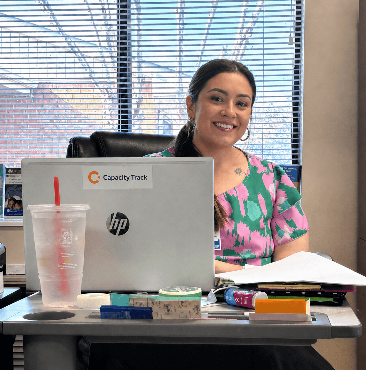 Capacity Track team member working at a laptop with Capacity Track branding